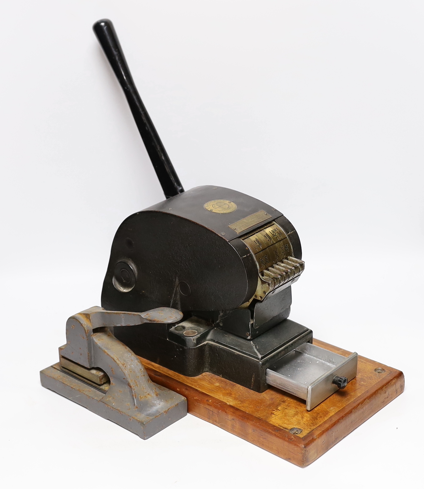 Two stamp perforators, a large example with adjustable date wheels and a smaller which stamps ‘& Co Not Negotiable’